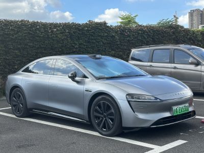 Front side view of a sleek electric sedan with aerodynamic styling and LED headlights