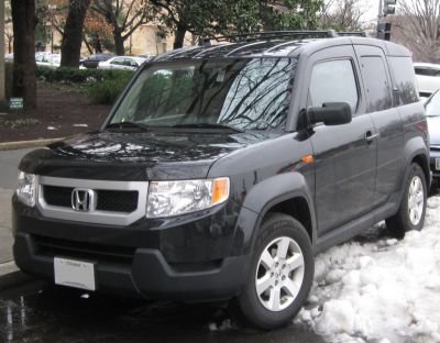 Boxy SUV with roof rails and alloy wheels in black color