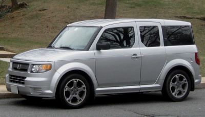Side profile of boxy silver SUV with five doors and prominent wheel arches