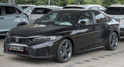 Sleek front and side view of a modern hatchback with sporty wheels and sharp headlights.