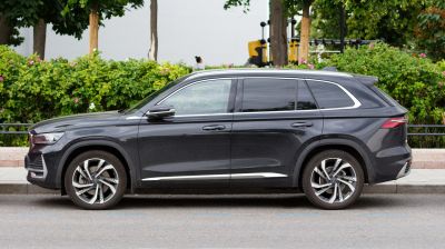 Side profile of a black SUV with alloy wheels and tinted windows