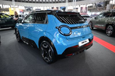 Rear view with unique circular LED taillights and sleek blue hatchback body