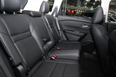 Spacious black leather rear seats with headrests and seatbelts
