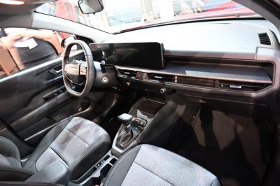 Modern car interior with wide digital display and compact automatic gearshift