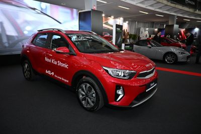 Red compact crossover with modern headlights and alloy wheels
