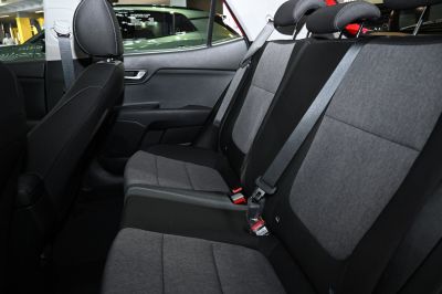 Rear seat with fabric upholstery and integrated seat belts