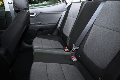 Rear seat interior with fabric upholstery and integrated seat belts