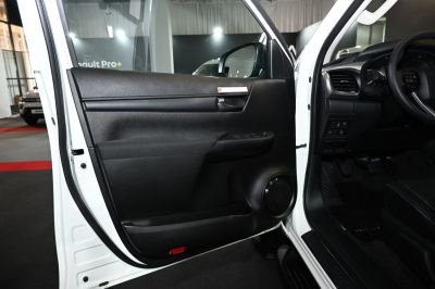 Interior door panel with controls and speaker of a modern pickup.