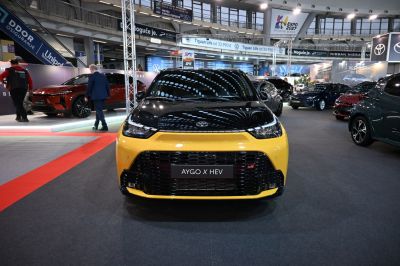 Sporty front view of a small hatchback with GR badge and yellow-black fascia