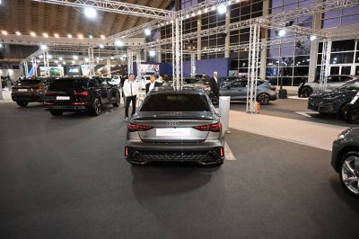 Rear view of a modern sedan with sleek tail lights and rear bumper design.