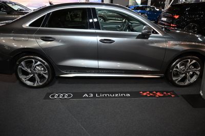 Side profile of a sleek sedan with distinctive alloy wheels