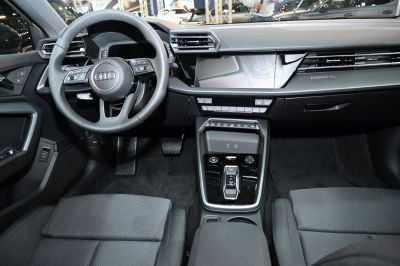 Modern car interior with digital instrument cluster and center console controls