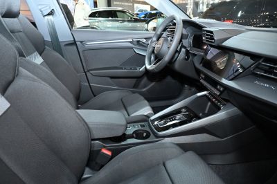 Modern car interior with digital dashboard and fabric seats