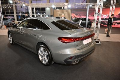 Modern sedan rear with LED tail lights and dual exhausts