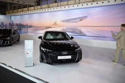 Front view of a sedan with large grille and sharp LED headlights