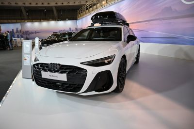 Luxury station wagon with roof cargo box and sleek styling