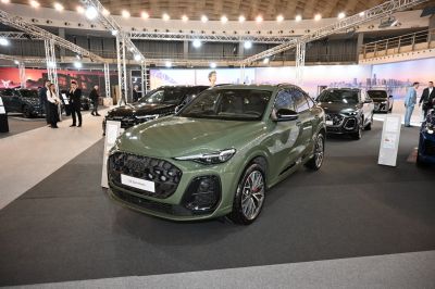 Green SUV with dark honeycomb grille and sleek LED headlights