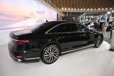 Rear side view of sleek black luxury sedan with alloy wheels