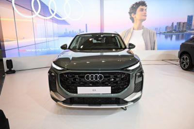 Front view with large black honeycomb grille and LED headlights