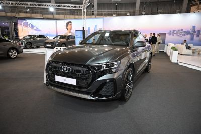 Close-up of SUV's large grille and angular LED headlights