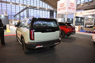 Rear view of SUV with vertical tail lights and two-tone black and beige paint.