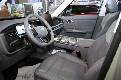 Modern steering wheel and digital dashboard with premium seating inside car