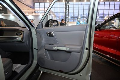 Interior door panel with ergonomic handle and textured design