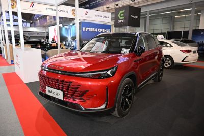 Bold front fascia and intricate grille of a modern SUV in red.