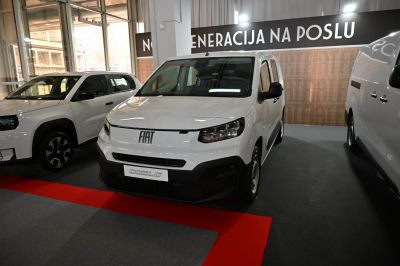 Front view of compact van with modern headlights and bold branding
