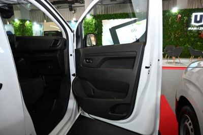 Driver side door interior panel with dashboard and side mirror.