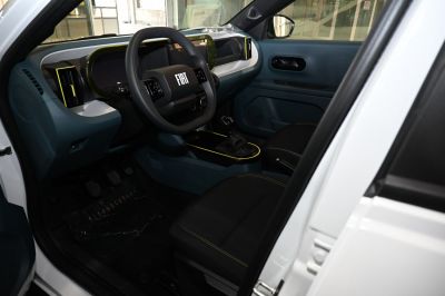 Modern dashboard with digital displays and distinctive steering wheel