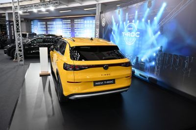 Rear view of yellow SUV with full-width taillight and sporty design