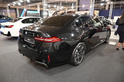 Rear side view of modern sedan with sleek taillights and alloy wheels