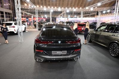 Rear view of a black luxury SUV with distinctive tail lights and dual exhausts