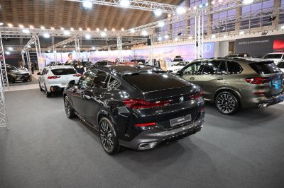 Rear view of a black luxury SUV showing tail lights and sport wheels