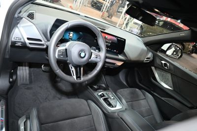 Modern digital dashboard and steering wheel in compact hatchback interior