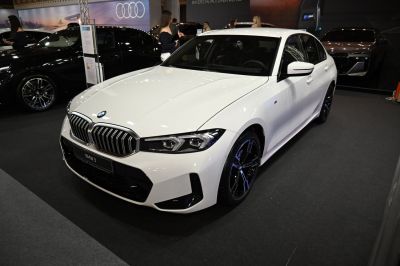 Prominent kidney grille and sharp LED headlights on a white sedan