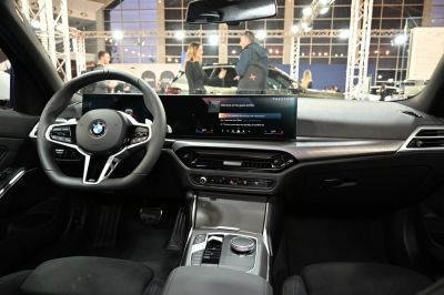 Modern car interior with digital dashboard and steering wheel controls.