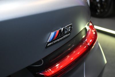 Close-up of rear competition badge and lit taillight