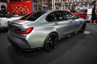 Matte silver car rear side with black alloy wheels and sporty design