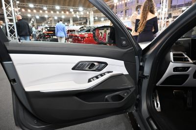 Interior door panel with controls and speaker in modern vehicle