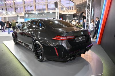 Black luxury sedan rear with quad exhaust and sleek modern tail lights
