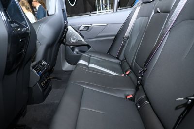 Rear seat interior with black leather upholstery and rear climate controls.