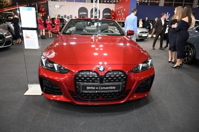 Front view of red BMW convertible with large kidney grille and LED headlights