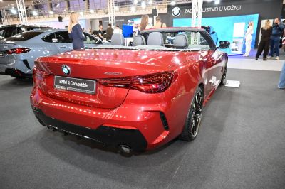 Rear view of a red convertible with LED tail lights and dual exhaust pipes