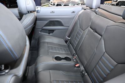 Black leather rear seats with blue stitching and cup holders
