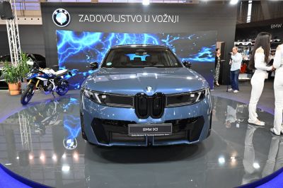 Front view of electric SUV with closed grille and sleek LED headlights