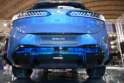 Rear view with illuminated tail lights and sleek bumper of electric SUV