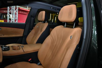 Tan leather front seats with perforation and detailed stitching.