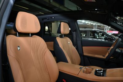 Tan leather car interior with quilted door panels and panoramic roof